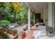 Cozy back patio with outdoor seating, brick floor, lots of potted plants and relaxing atmosphere at 3325 Falls River Ave, Raleigh, NC 27614