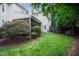 Charming backyard with lush lawn, mature landscaping, screened porch and rear entry door at 3325 Falls River Ave, Raleigh, NC 27614