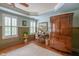 Bedroom with hardwood floors, built-in storage, desk, and abundant natural light at 3325 Falls River Ave, Raleigh, NC 27614