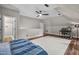 Bright bedroom with hardwood floors, a modern ceiling fan, and a desk area for added functionality at 3325 Falls River Ave, Raleigh, NC 27614