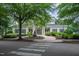 Welcoming clubhouse featuring a classic architectural design, surrounded by lush greenery and a well-maintained landscape at 3325 Falls River Ave, Raleigh, NC 27614