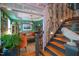 Elegant entryway with hardwood floors, staircase, designer wallpaper, and view to the green living room at 3325 Falls River Ave, Raleigh, NC 27614