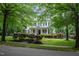 Charming two-story home with black shutters, brick front steps, and professionally landscaped yard at 3325 Falls River Ave, Raleigh, NC 27614