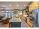 Spacious kitchen boasts custom yellow cabinets, stainless steel appliances, and an adjacent living area at 3325 Falls River Ave, Raleigh, NC 27614