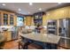 Spacious kitchen with custom cabinets, modern appliances, and an island with barstool seating at 3325 Falls River Ave, Raleigh, NC 27614