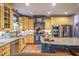 Charming kitchen featuring a center island, custom cabinets, and stainless steel appliances at 3325 Falls River Ave, Raleigh, NC 27614