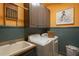 Convenient laundry room with modern washer and dryer, ample cabinet space, sink and a decorative octopus wall art at 3325 Falls River Ave, Raleigh, NC 27614