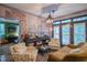 Comfortable living area with ample seating, a unique wall mural, and elegant light fixtures at 3325 Falls River Ave, Raleigh, NC 27614