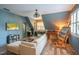 Cozy living room with a large sectional sofa, hardwood floors, and a built-in desk with a painting easel at 3325 Falls River Ave, Raleigh, NC 27614