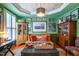 Inviting living room featuring bright green walls, elegant furnishings, and abundant natural light at 3325 Falls River Ave, Raleigh, NC 27614