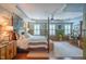 Inviting main bedroom with four poster bed, designer wallpaper, and natural light at 3325 Falls River Ave, Raleigh, NC 27614