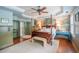 Serene main bedroom with four poster bed, designer wallpaper, and natural light at 3325 Falls River Ave, Raleigh, NC 27614