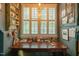 Office space featuring a wooden desk, shuttered windows, a pendant light, and decor at 3325 Falls River Ave, Raleigh, NC 27614