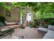View of a relaxing brick patio with comfortable seating and decorative potted plants at 3325 Falls River Ave, Raleigh, NC 27614