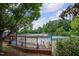 Community pool area with ample seating and shady umbrellas on a bright day at 3325 Falls River Ave, Raleigh, NC 27614
