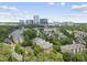 Aerial view of apartments surrounded by lush trees with high rise buildings in the distance at 340 Allister Dr # 301, Raleigh, NC 27609