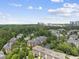 View of a community complex nestled among trees and manicured lawns at 340 Allister Dr # 301, Raleigh, NC 27609