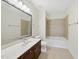 Bathroom with large mirror, vanity with dark wood cabinets, and shower-tub combination at 340 Allister Dr # 301, Raleigh, NC 27609