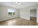 Comfortable bedroom with hardwood floors, a large window, and ample natural light at 340 Allister Dr # 301, Raleigh, NC 27609