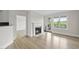 Bright living room with fireplace and balcony access, with view to the outside and wood floors at 340 Allister Dr # 301, Raleigh, NC 27609