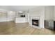 Spacious living room with a mini fridge, fireplace, and seamless flow to the dining area and kitchen at 340 Allister Dr # 301, Raleigh, NC 27609