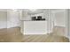 Open living area with hardwood floors, leading to the kitchen area with granite countertops at 340 Allister Dr # 301, Raleigh, NC 27609