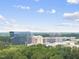 View of a business building over the tree line at 340 Allister Dr # 301, Raleigh, NC 27609