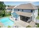 Aerial view of the backyard with swimming pool, patio, screened-in porch, patio furniture, and trees at 3536 Greenville Loop Rd, Wake Forest, NC 27587