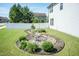 Backyard features a rock garden, manicured landscaping and a well-maintained lawn at 3536 Greenville Loop Rd, Wake Forest, NC 27587