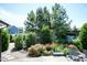 Backyard landscaping features lush greenery and a variety of flowering plants, creating a private outdoor retreat at 3536 Greenville Loop Rd, Wake Forest, NC 27587