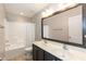 Bathroom features a double vanity with large mirror and shower-tub combination at 3536 Greenville Loop Rd, Wake Forest, NC 27587