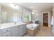 Bright bathroom with dual sinks, soaking tub, and window offering natural light at 3536 Greenville Loop Rd, Wake Forest, NC 27587