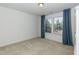 Bright bedroom features neutral carpet, white walls, window with blinds and blue curtains at 3536 Greenville Loop Rd, Wake Forest, NC 27587