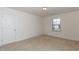 Cozy bedroom with plush carpet, bright window, and neutral paint at 3536 Greenville Loop Rd, Wake Forest, NC 27587
