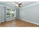Bedroom with hardwood floors, ceiling fan, and window with curtains at 3536 Greenville Loop Rd, Wake Forest, NC 27587