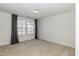 Bright bedroom features neutral carpet, white walls, window with blinds and grey curtains at 3536 Greenville Loop Rd, Wake Forest, NC 27587