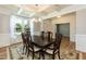 Dining room featuring wood floors, a coffered ceiling, a chandelier, and large windows at 3536 Greenville Loop Rd, Wake Forest, NC 27587