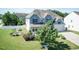 Two-story home with white vinyl privacy fence and well manicured front lawn with mature trees and bushes at 3536 Greenville Loop Rd, Wake Forest, NC 27587