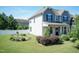 Well-maintained home featuring a landscaped garden, fresh green lawn, and white vinyl privacy fence at 3536 Greenville Loop Rd, Wake Forest, NC 27587