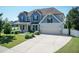 Two-story home with a long driveway, two car garage, manicured lawn, blue siding and a front porch at 3536 Greenville Loop Rd, Wake Forest, NC 27587