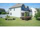 Two-story home with blue and white siding, manicured lawn, and lush landscaping at 3536 Greenville Loop Rd, Wake Forest, NC 27587