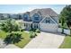 Beautiful two-story home with blue siding, black shutters, a two-car garage and a manicured lawn at 3536 Greenville Loop Rd, Wake Forest, NC 27587