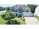 Well-kept two-story home with blue siding, black shutters, a two-car garage, and a freshly cut lawn at 3536 Greenville Loop Rd, Wake Forest, NC 27587