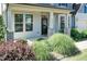 Inviting front porch with stone pillars and a beautifully landscaped garden at 3536 Greenville Loop Rd, Wake Forest, NC 27587