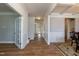 Bright hallway featuring wood floors, white trim, and natural light from the entry door at 3536 Greenville Loop Rd, Wake Forest, NC 27587