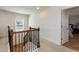Bright hallway with carpet and wood stairs, natural light, and doorway with wood floors at 3536 Greenville Loop Rd, Wake Forest, NC 27587