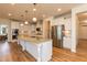 Bright kitchen features granite counters, stainless steel appliances, recessed lights, and white cabinets at 3536 Greenville Loop Rd, Wake Forest, NC 27587