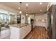 Open kitchen boasts a large island, granite counters, stainless steel appliances and is connected to the living room at 3536 Greenville Loop Rd, Wake Forest, NC 27587