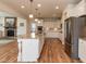 Bright, spacious kitchen boasts a large island, granite counters, stainless steel appliances, and hardwood floors at 3536 Greenville Loop Rd, Wake Forest, NC 27587