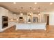 White kitchen with stainless steel appliances, granite countertops, and hardwood floors at 3536 Greenville Loop Rd, Wake Forest, NC 27587